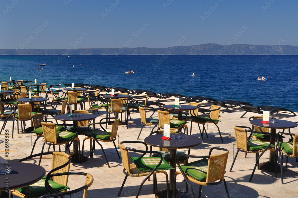 Tables and chairs of restaurant in beach of Podgora