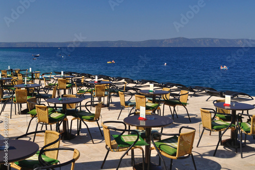 Tables and chairs of restaurant in beach of Podgora
