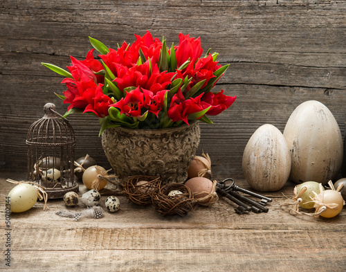 Fototapeta Naklejka Na Ścianę i Meble -  vintage easter decoration with eggs and red tulips