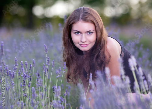 Young woman in the field of blossoming lavender