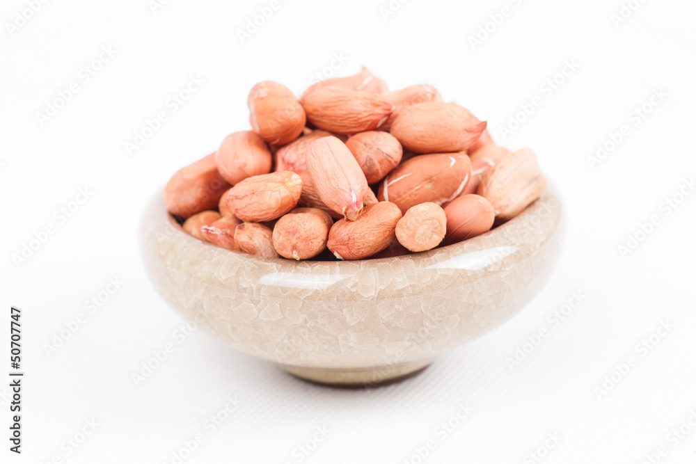 Peanuts in bowl on white Peanuts in bowl on white