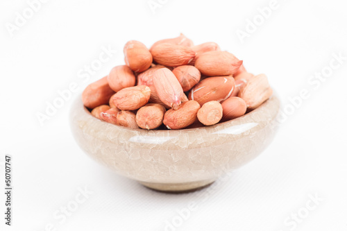 Peanuts in bowl on white