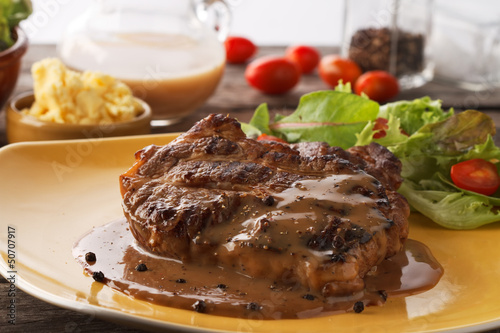 closed up grilled steak flavoured with  pepper and gravy
