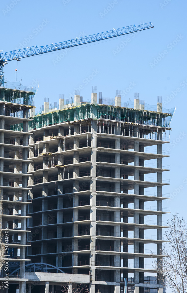 Large building under construction in sunny day Large building under construction in sunny day