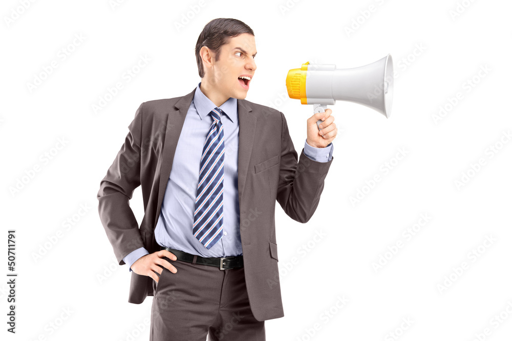 An angry young businessman announcing via megaphone An angry young businessman announcing via megaphone