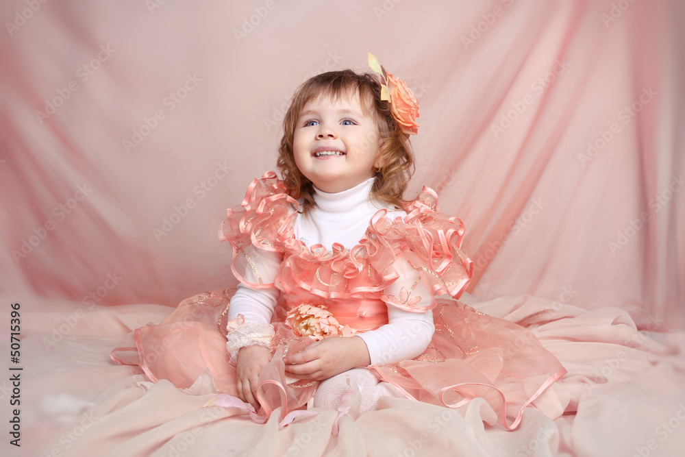 Happy smiling funny little girl looking up over drapery Happy smiling funny little girl looking up over drapery