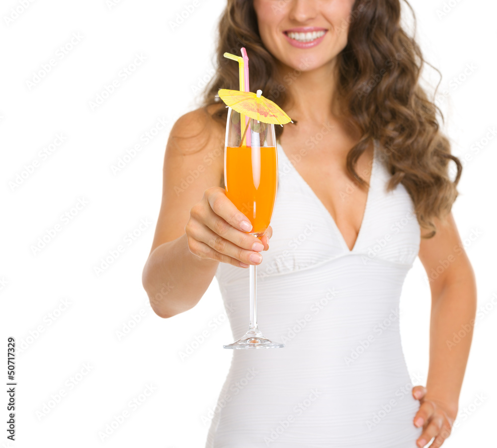 Fototapeta premium Closeup on young woman in swimsuit giving cocktail