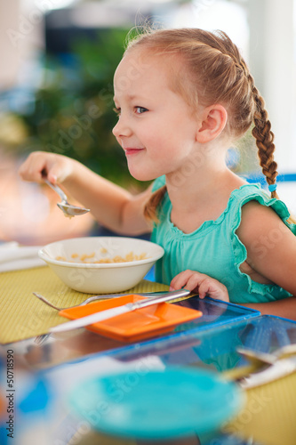 Little girl having breakfast