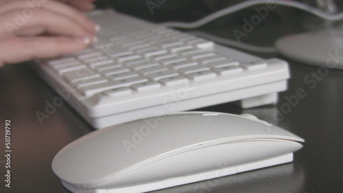 Close up of a hand typing on keyboard. photo