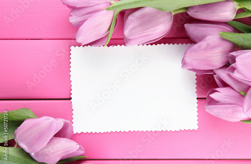 Beautiful bouquet of purple tulips and blank card © Africa Studio