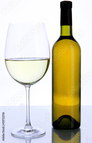 White wine glass and bottle of wine isolated on white