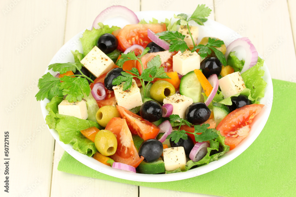 Fresh salad in plate on wooden table Fresh salad in plate on wooden table