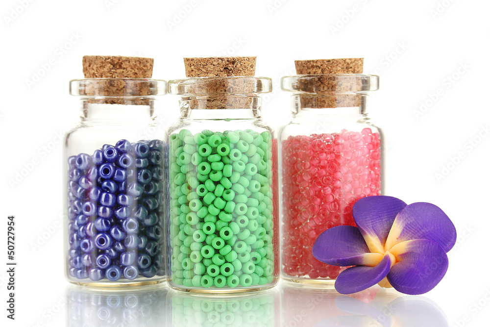 Little bottles full with colorful beads isolated on white Little bottles full with colorful beads isolated on white