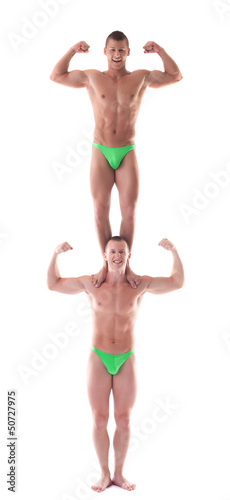 Two smiling force acrobat posing in studio