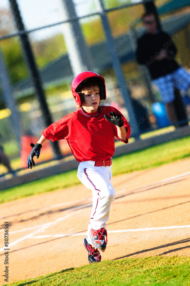 Little league baseball player running