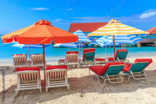 Beach chairs and parasols on a beach in a tropical paradise