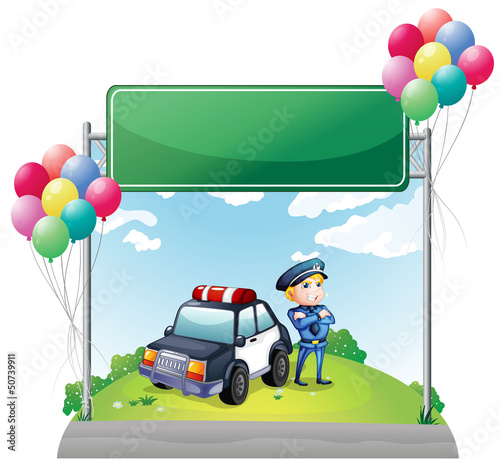 A policeman with his car near the green empty board