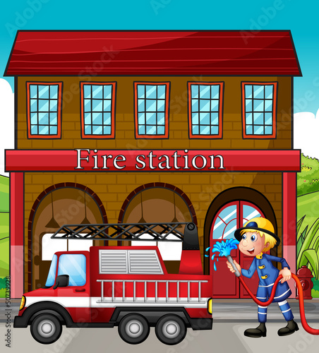 A fireman and a fire truck in front of the fire station