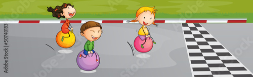 Three kids racing at the street