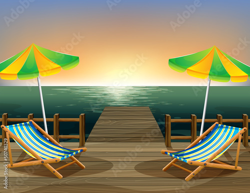 The beach umbrellas and the foldable chairs at the bridge