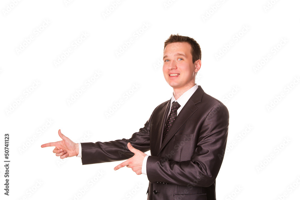 Happy young friendly smiling businessman pointing finger Happy young friendly smiling businessman pointing finger