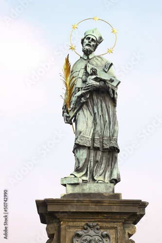 One of sculptures on the Karlov bridge in Prague photo