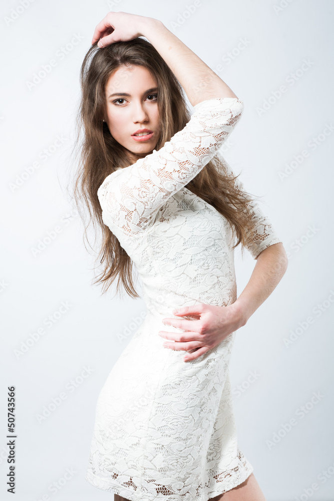 Gorgeous fashionable girl posing in light background Gorgeous fashionable girl posing in light background