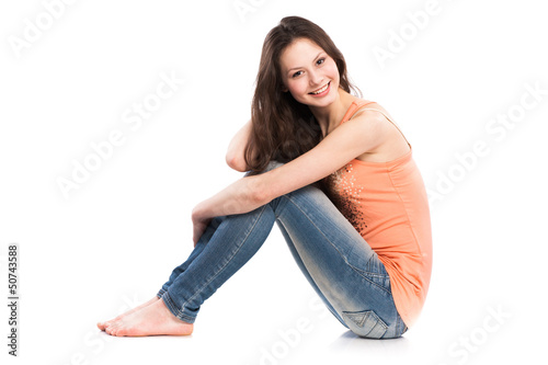 Attractive caucasian girl sitting on floor