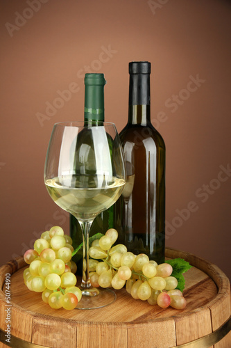 Composition of wine bottles, glass of white wine, grape