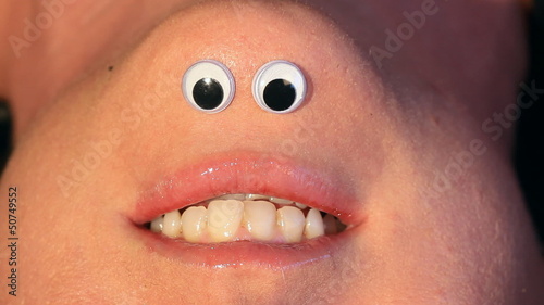 Mrs Chinigan talks.  Cartoon eyes on inverted female face.