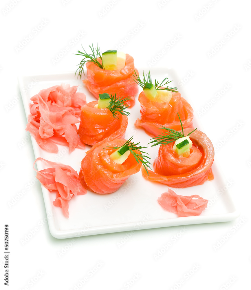 rolls of trout with cucumber on a white background rolls of trout with cucumber on a white background