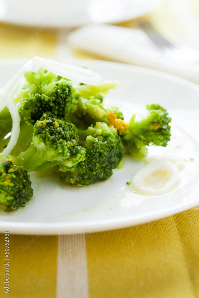 stewed pieces of broccoli on a white dish stewed pieces of broccoli on a white dish