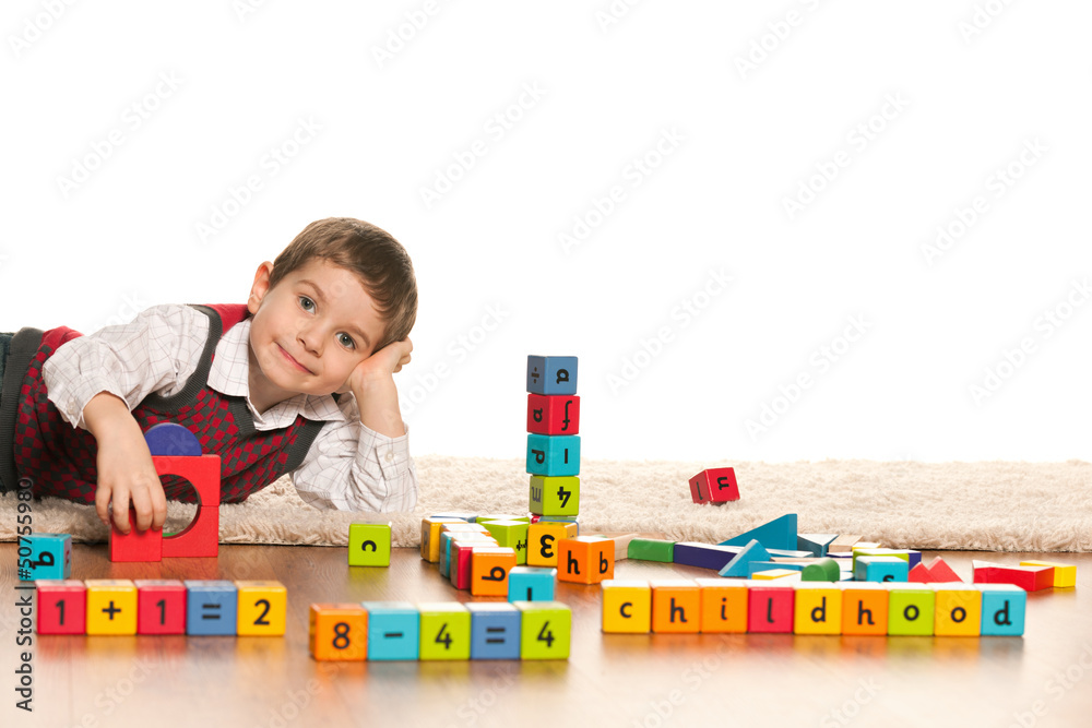 Fototapeta premium Playing with toys little boy