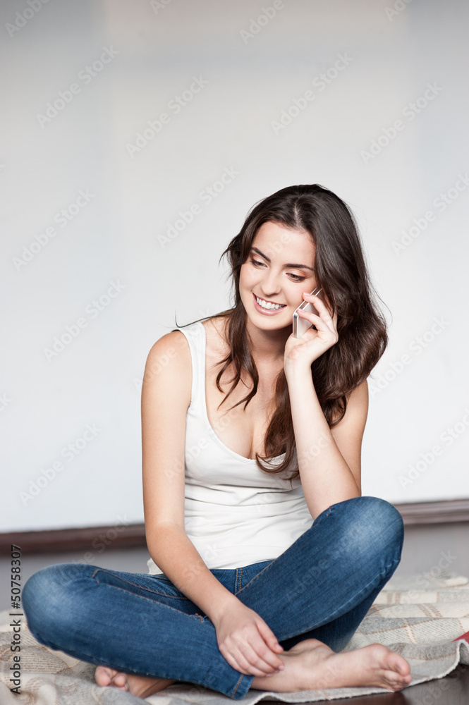 casual brunette girl holding cell phone casual brunette girl holding cell phone