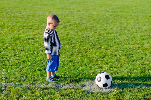 Little boy about to kick a soccer ball