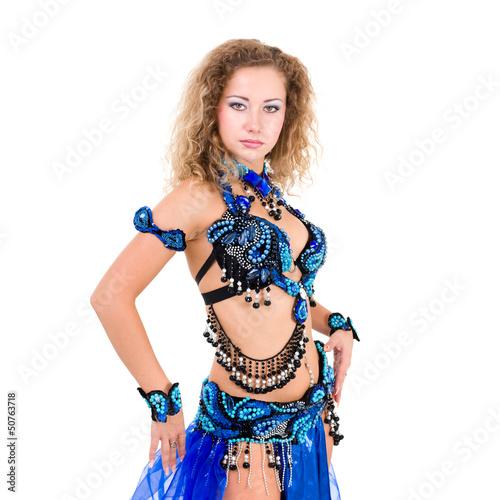Young beautiful belly dancer in a blue costume