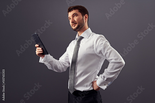 businessman holding tablet pc and looking up © ArtFamily