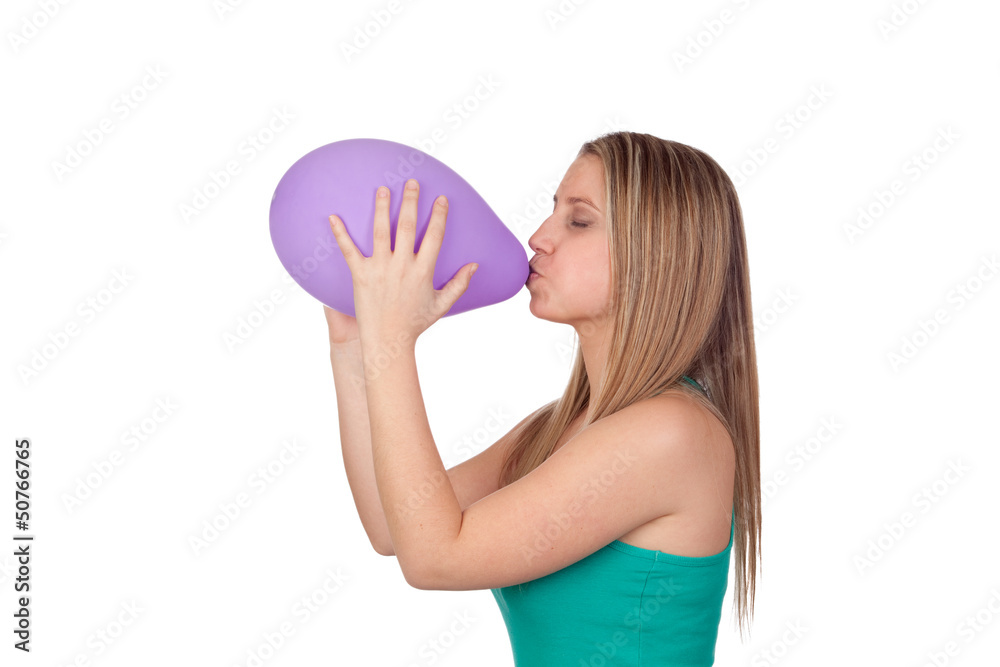 Attractive blond girl swelling a purple balloon Attractive blond girl swelling a purple balloon