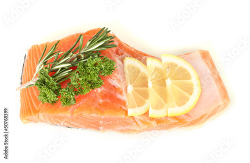 Fresh salmon fillet with herbals and lemon slices, isolated