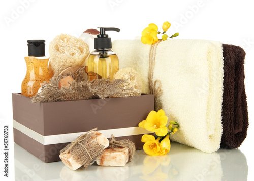 Composition of cosmetic bottles and soap in crate, isolated