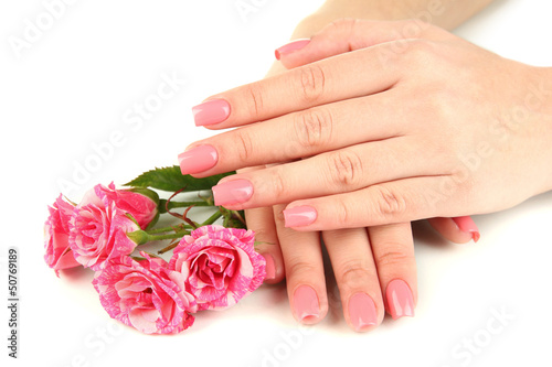 Woman hands with pink manicure and flowers  isolated on white