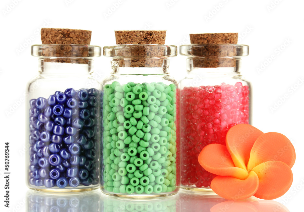 Little bottles full with colorful beads isolated on white Little bottles full with colorful beads isolated on white