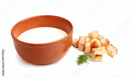 Sour cream in a bowl with croutons and dill photo