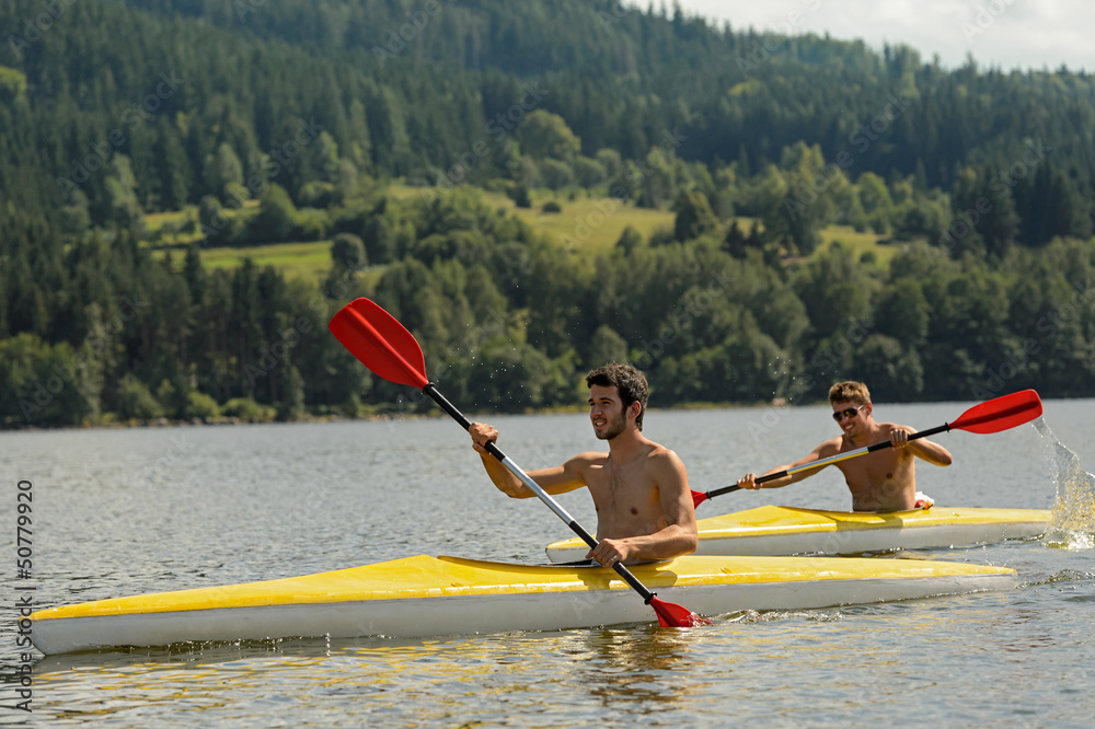 Kayaking sporty men on river sunshine