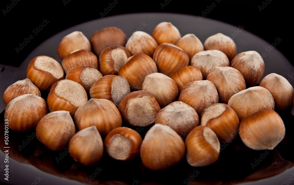 hazelnuts on a black background