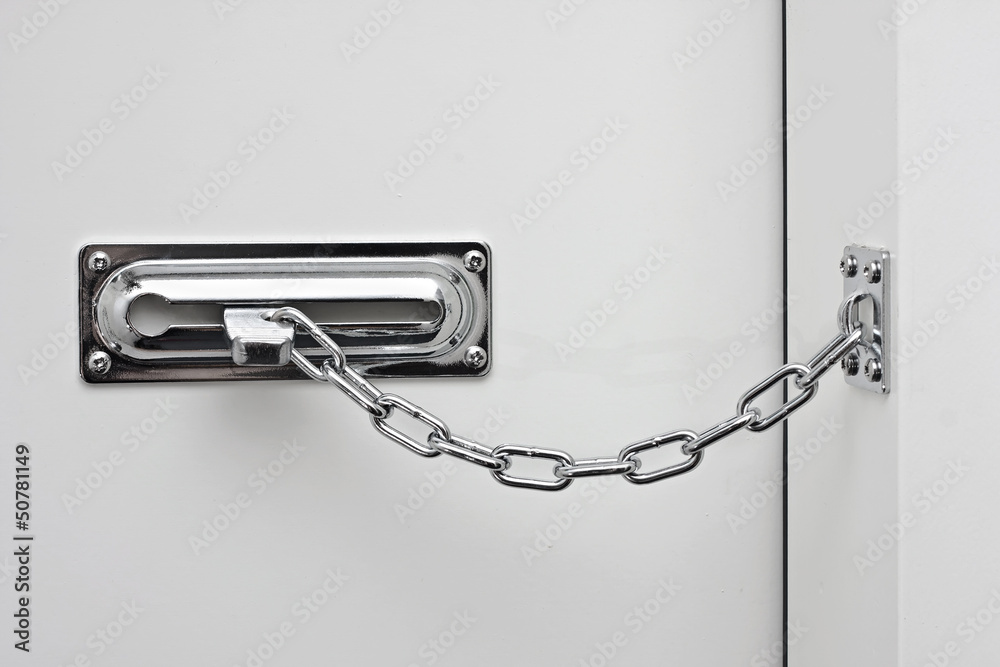 Fototapeta premium the white door is closed on a silvery chain