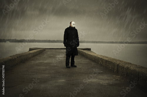 man with white mask near the river photo
