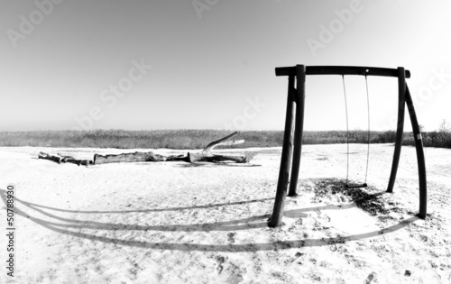 Winter landscae with swing photo