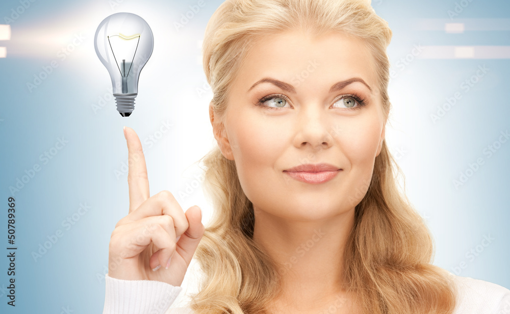 woman pointing her finger at light bulb woman pointing her finger at light bulb