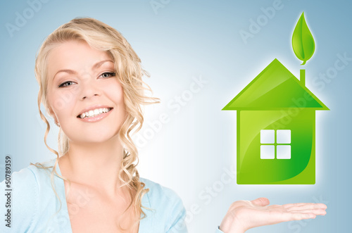 woman holding green house in her hands